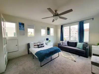 a living room with a bed and a couch at Upscale Modern Townhouse at Balboa Park in San Diego