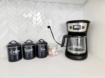 a coffee maker on a counter next to four trash cans at Upscale Modern Townhouse at Balboa Park in San Diego