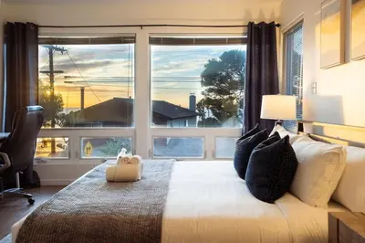 a bedroom with a bed and a large window at Sunset Serenity On The Cliffs - Balcony- Oceanview in San Diego