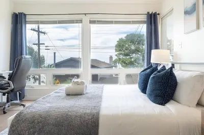 a bedroom with a bed and a large window at Sunset Serenity On The Cliffs - Balcony- Oceanview in San Diego