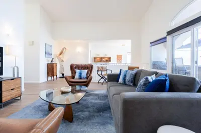 a living room with a couch and a table at Sunset Serenity On The Cliffs - Balcony- Oceanview in San Diego