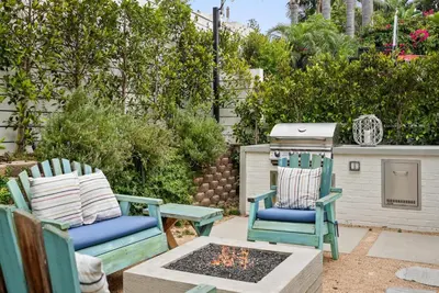 two chairs and a fire pit in a yard at Neptune Hidden Gem in Encinitas