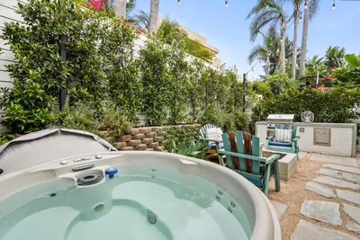 a jacuzzi tub in the backyard of a house at Neptune Hidden Gem in Encinitas