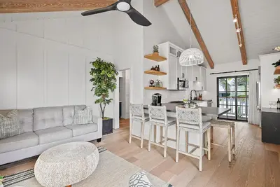 a living room with a couch and a table at Neptune Hidden Gem in Encinitas