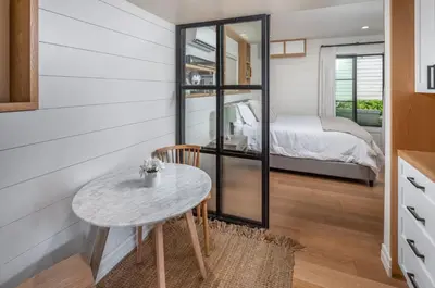 a small table in a room with a bedroom at Neptune Charm in Encinitas