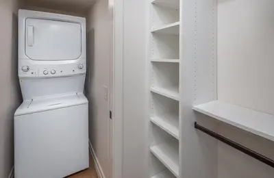 a washer and dryer in a white laundry room at Neptune Charm in Encinitas