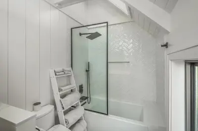 a bathroom with a shower and a toilet and a ladder at Neptune Ocean View Masterpiece in Encinitas