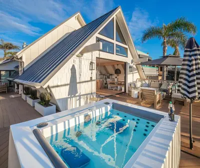 a house with a swimming pool in front of a house at Neptune Ocean View Masterpiece in Encinitas