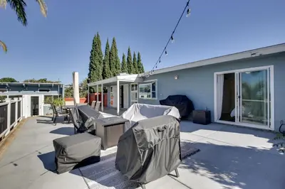 a patio with chairs and tables and a building at San Diego Home Private Outdoor Pool and Game Room! in San Diego