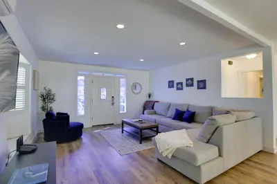 a living room with a couch and a table at San Diego Home Private Outdoor Pool and Game Room! in San Diego