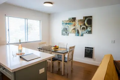 a kitchen and dining room with a table and chairs at 1 Block from Beach - Steps from Restaurants & Shops in Oceanside