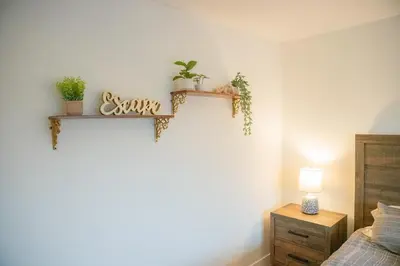 a bedroom with two shelves on the wall with plants at 1 Block from Beach - Steps from Restaurants & Shops in Oceanside