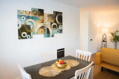 a dining room with a table with a bowl of fruit on it at 1 Block from Beach - Steps from Restaurants & Shops in Oceanside