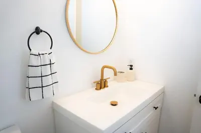 a bathroom with a sink and a mirror at 1 Block from Beach - Steps from Restaurants & Shops in Oceanside