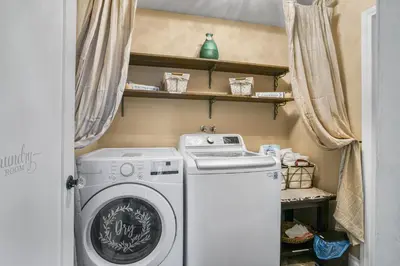 a small laundry room with a washer and dryer at Luxury Cozy Studio with Firepit in Vista