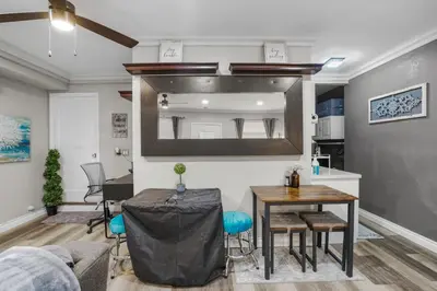 a living room with a table and a mirror at Luxury Cozy Studio with Firepit in Vista