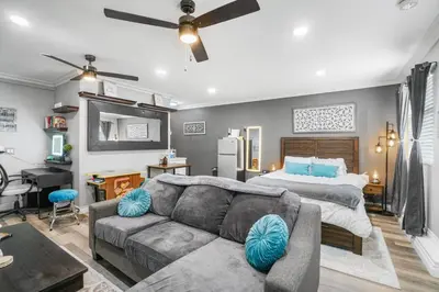 a living room with a couch and a bed at Luxury Cozy Studio with Firepit in Vista