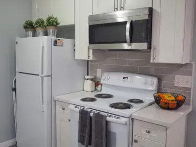 a kitchen with a white stove and a refrigerator at Charming 1Bedroom Vacation Condo in Oceanside
