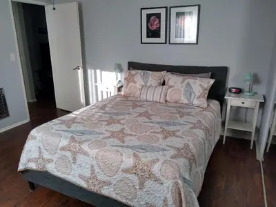 a bedroom with a large bed and a table at Charming 1Bedroom Vacation Condo in Oceanside