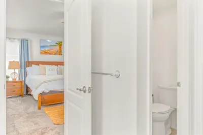 a white room with a bed and a toilet at Villa Descanso in Oceanside