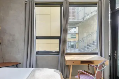 a bedroom with a bed and a desk and a window at East Village 1br w spa media room nr stadium SAN-37 in San Diego