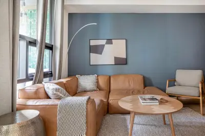 a living room with a brown couch and a table at East Village 1br w spa media room nr stadium SAN-37 in San Diego