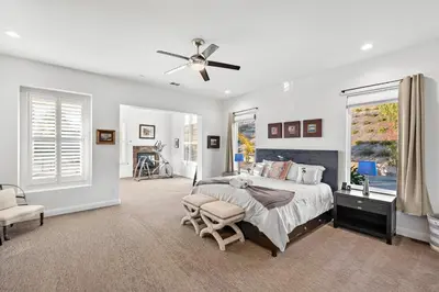 a bedroom with a bed and a ceiling fan at Luxury Home With Pool & Tennis Court in Fallbrook