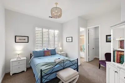 a bedroom with a blue bed and a chair at Luxury Home With Pool & Tennis Court in Fallbrook