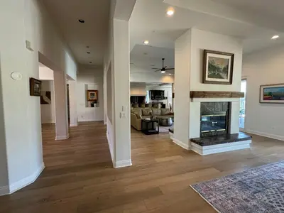 a living room with a fireplace in a house at Luxury Home With Pool & Tennis Court in Fallbrook