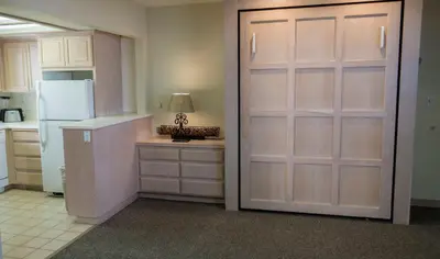 a kitchen with two sliding doors and a refrigerator at Casa De La Playa in San Diego
