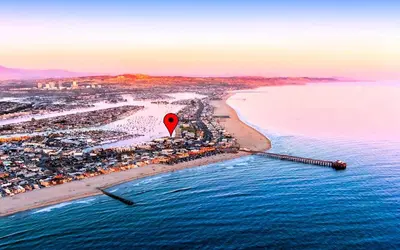 an aerial view of a beach with a red marker at Luxury 2BR Steps to Beach & Pier with AC plus Garage Parking in Newport Beach
