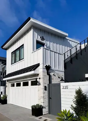 a white house with a white garage at Luxury 2BR Steps to Beach & Pier with AC plus Garage Parking in Newport Beach