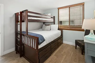 a bedroom with a bunk bed and a window at Stunning Beach Home - large patio, parking, ac & dog friendly! in San Diego