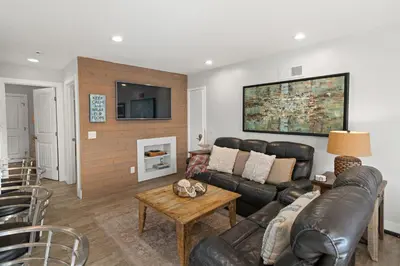 a living room with a couch and a table at Stunning Beach Home - large patio, parking, ac & dog friendly! in San Diego