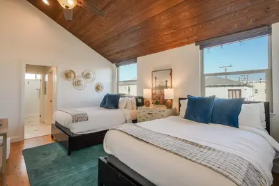a bedroom with two beds and a window at Stunning South Mission Beach Home - AC, Private Patio, Grill and Garage! in San Diego