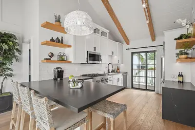 a kitchen with a black counter top in a room at Neptune Experience in Encinitas