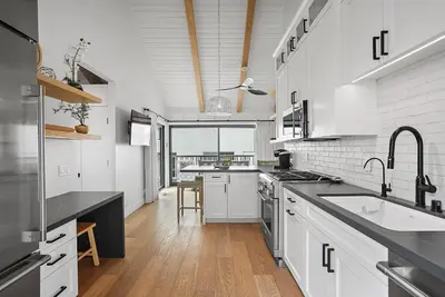 a large kitchen with white cabinets and a sink at Neptune Experience in Encinitas