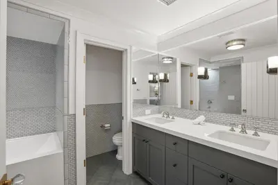 a bathroom with two sinks and a toilet and a mirror at Coastal La Jolla Luxury w AC, Patios, & Massive Ocean Views! in San Diego