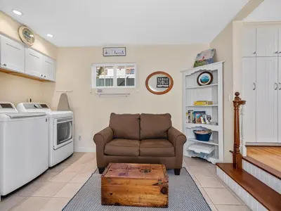 a living room with a couch and a table at Stunning beach home - steps2sand, AC, Large Patio and Fast Wifi! in San Diego