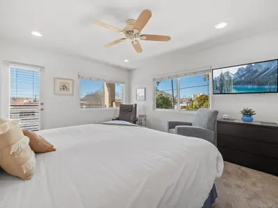 a bedroom with a white bed and a ceiling fan at Pacific Beach Paradise - Near the Beach w AC, Garage, Fast Wifi & Private Patio! in San Diego