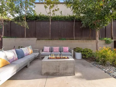 a patio with two couches and a fire pit at Luxury Coastal Home - Pool, Spa, AC, & Ocean Views in Solana Beach
