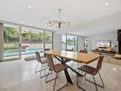 a dining room with a table and chairs at Luxury Coastal Home - Pool, Spa, AC, & Ocean Views in Solana Beach