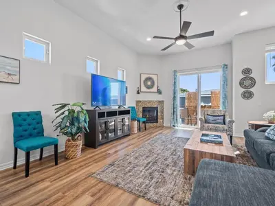 a living room with a couch and a tv at Pacific Beach Dreaming - AC, walk 2 town, garage & beach in San Diego