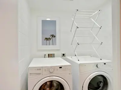 a white laundry room with a washer and dryer at Haines Luxury Dream Home - Bay Views, Rooftop, Fire Pit & AC in San Diego