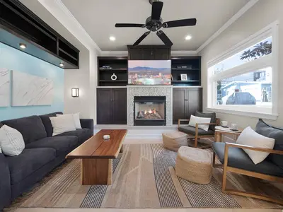 a living room with a couch and a fireplace at Kennebeck Oasis - Private Patio, Steps 2 Sand & AC in San Diego