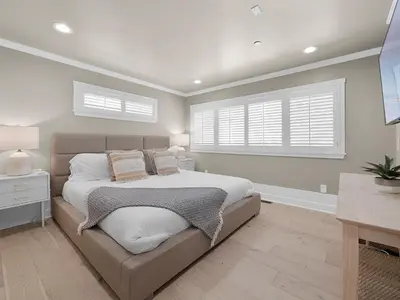 a bedroom with a large bed and two windows at Kennebeck Oasis - Private Patio, Steps 2 Sand & AC in San Diego