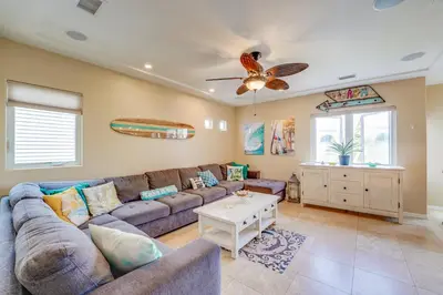 a living room with a couch and a ceiling fan at Stunning Ocean View Home w Rooftop Terrace, Firepit, Fast Wifi, AC & Parking! in San Diego