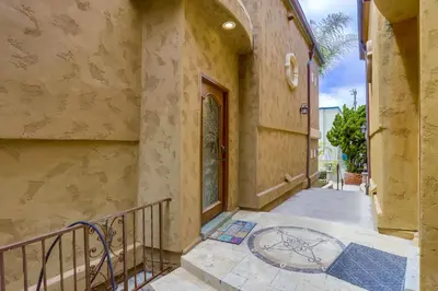 an empty hallway of a building with a staircase at Stunning Ocean View Home w Rooftop Terrace, Firepit, Fast Wifi, AC & Parking! in San Diego