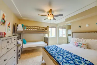 a bedroom with two bunk beds and a ceiling fan at Stunning Ocean View Home w Rooftop Terrace, Firepit, Fast Wifi, AC & Parking! in San Diego