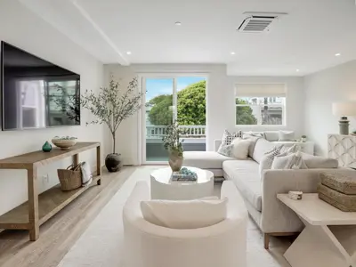 a living room with a couch and a table at Coastal retreat near the beach w Panoramic Ocean Views, Rooftop Deck, & Firepit in San Diego